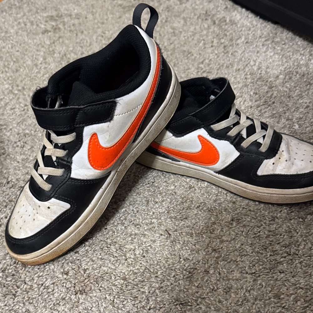 Nike Kids' Black and White Shoes with Vibrant Orange Logo